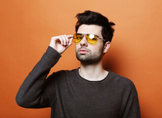 Fototapeta premium Handsome young man in smart casual wear with sunglasses
