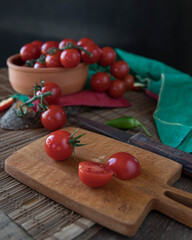 Tomatoes and chili pepper on a chopping board. Chili peppers on a wooden chopping board top view. Chili pepper. Red and yellow  chili peppers close up . 