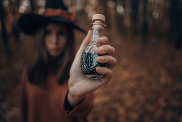 love drink: witch's potion in a glass bottle in hand
