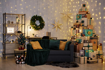 Christmas interior - decorated living room with tower of gift boxes in shape of christmas tree