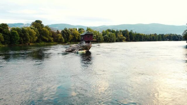 Small wooden cabin on a rock in the middle of river Drina, Serbia.