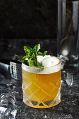 cocktail with mint and lime over black background