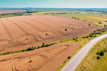 Top view of cultivated agricultural field and highway. Rural summer landscape