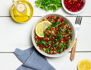 Tabbouleh salad with bulgur, mint, parsley, tomatoes and pomegranate. Healthy eating. Vegetarian food.