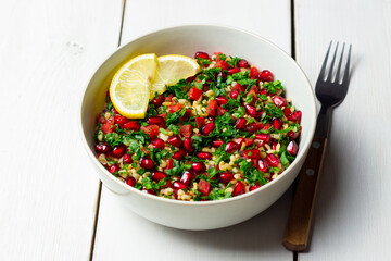 Tabbouleh salad with bulgur, mint, parsley, tomatoes and pomegranate. Healthy eating. Vegetarian food.