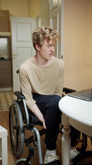 A young disabled man is massaging his legs 