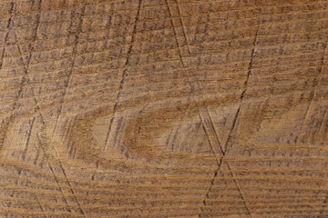 texture of wood in a warm shade and cuts on the surface background