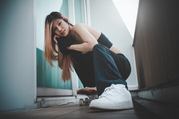 Asian Fashion model girl is posing with white sneakers shoes and skateboard for street fashion © junce11