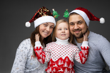 Friendly family of three standing together and smiling