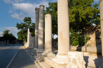 Fototapeta premium ancient theater exterior, Antalya Side. road and columns. no people. sunset sky. cloudy spring day. Selective focus.