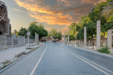 Fototapeta premium ancient theater exterior, Antalya Side. road and columns. no people. sunset sky. cloudy spring day. Selective focus.