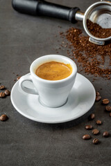 Fresh espresso coffee with coffee beans on dark background
