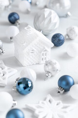 White toy house with blue, white and silver Christmas decorations