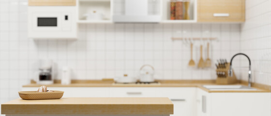 Light wooden kitchen counter top and space for montage on blurred white kitchen interior background