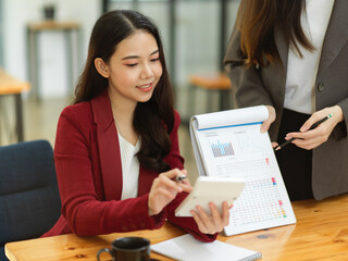 Financial team presents financial results on a spreadsheet and graph chart in the meeting