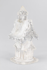 Glass christmas figurine of a house with snow. christmas Composition on gray background. Home sweet home christmas concept