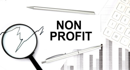 NON PROFIT document with pen,graph and magnifier,calculator,business