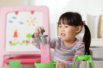 young girl making slime at home