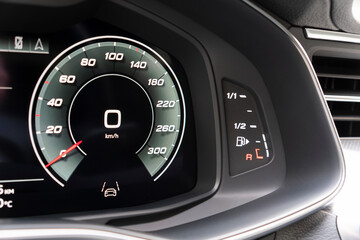 Close up shot of a digital speedometer in car. Fully digital car dashboard. Dashboard details with indication lamps. Car instrument panel.