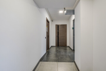 long white empty corridor in interior of entrance hall of modern apartments, office or clinic