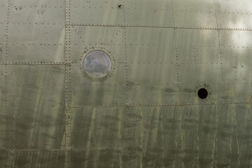 Details of the fuselage of an old aircraft. Old camouflage surface on a military aircraft 