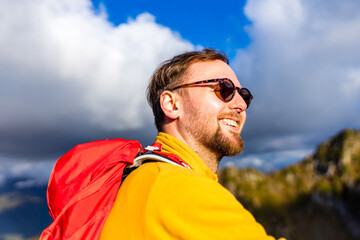 snow white smiling man with braces in mountains . concept of teeth care far from home