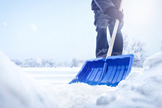 Person using a snow shovel in winter