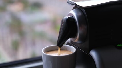 Close up of a coffee machine pouring an expresso in a cup. - obrazy, fototapety, plakaty