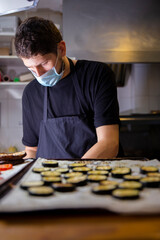 cook in the kitchen of a restaurant preparing food