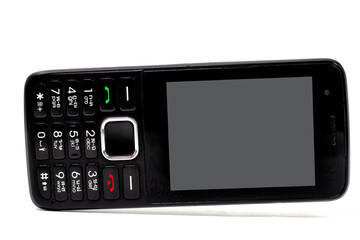 A black old phone is tilted against isolated on a white background, Old communication tools, portable phones.