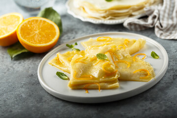 Traditional homemade French pancakes with orange sauce
