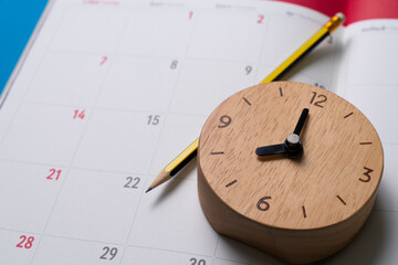 close up of calendar and clock on the blue table background, planning for business meeting or...