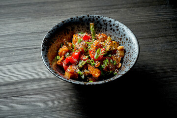 Crispy wok chicken pieces in sweet and sour sauce with vegetables
