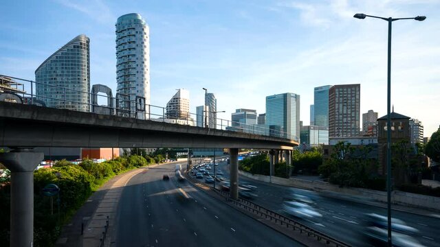 Busy junction traffic time-lapse with London skyscrapers in the background