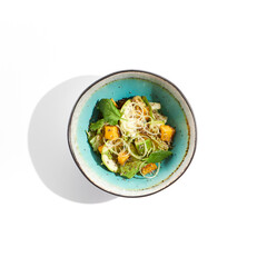Fresh healthy food - green salad with avocado, mango. Vegetarian dish for restaurant on white background. Healthy organic vegan food. Healthy vegetarian lunch. Detox salad for diet. Eat less meat.