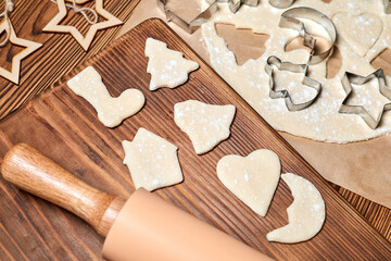 Making gingerbread Christmas Cookies Using form for cooking on wooden background