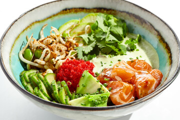 Healthy food - poke bowl with salmon, rice, cucumber, avocado, edamame beans, soybean sprouts and ponzu sauce. Hawaiian meal poke bowl with salmon isolated on white background.
