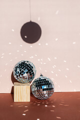 christmas decoration disco ball with sun flares and blurred foreground