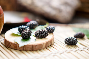 Ripe large black mulberries close up