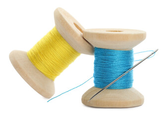 Colorful sewing threads with needle on white background, closeup