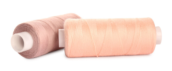 Different colorful sewing threads on white background, closeup