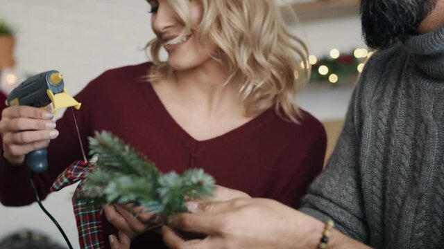 Happy couple preparing decorations for Christmas. Shot with RED helium camera in 8K   