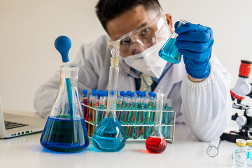 Fototapeta premium science laboratory test tube A device for young healthcare researchers working in life science laboratories. A young man research scientist prepares and analyzes with a microscope
