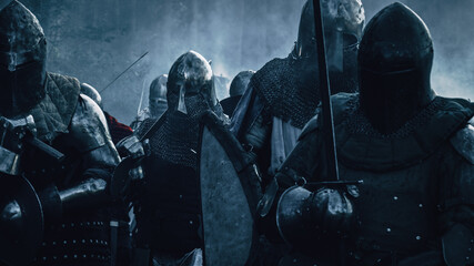 Fototapeta na wymiar Ancient Invading Army of Medieval Knights Marching on Battlefield. Plate Body Armored Warriors Walking. War, Battle and Conquest. Epic Cinematic Shot. Professional Historical Reenactment