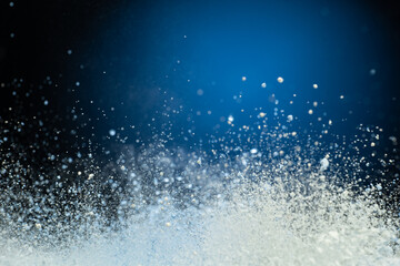 explosion of flour and components, lifting them into the air on a white surface
