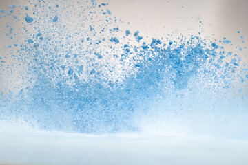 explosion of flour and components, lifting them into the air on a white surface