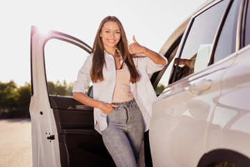 Photo of sweet cute young lady dressed white shirt smiling open automobile door showing thumb up...