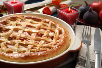 Delicious homemade apple pie and autumn decor on table, closeup. Thanksgiving Day celebration