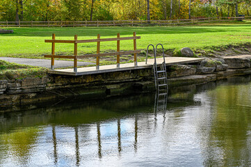 Fototapeta na wymiar overlooking water lawn and jetty with bathing ladder