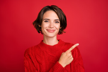 Photo of young attractive woman happy positive smile point finger empty space ads suggest isolated...